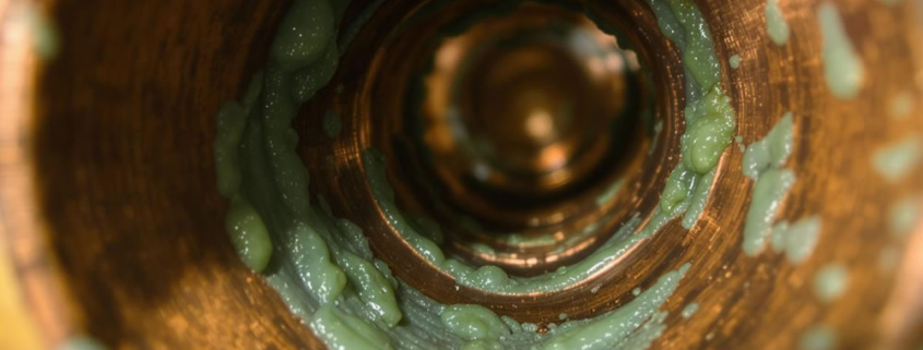 Biofilm contamination to the inside surfaces of a copper pipe