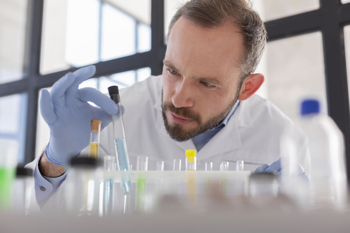 Scientist inspecting water samples during water quality testing Scientist inspecting water samples during water quality testing