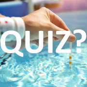 Pool operator testing swimming pool water quality with a test strip during a routine swimming pool health assessment.